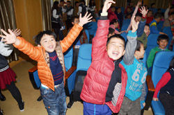 Children give a rousing round of applause for the quiz