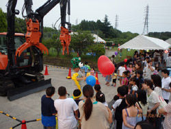 Children line up in front of the Balloon Man
