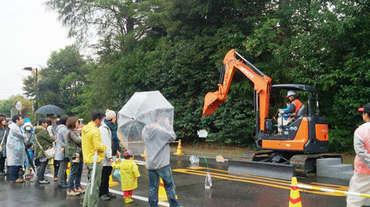 Children stood in a long line to try out the mini excavator