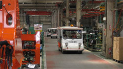 Visitors touring the assembly plant (touring the plant in an electric cart)
