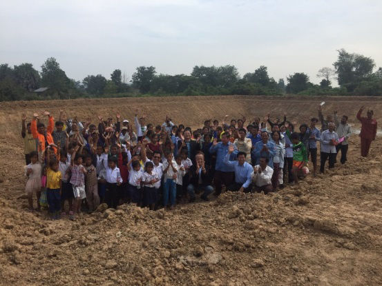 Ceremony participants standing in the middle of the completed reservoir