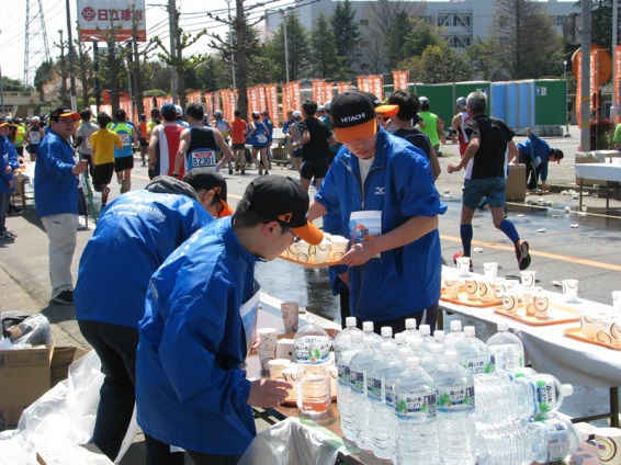 Employees volunteering at a water station