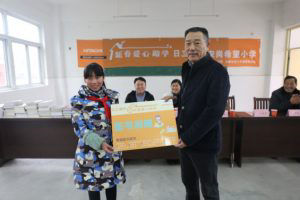 JianJun Wang, Deputy General Manager, Management Headquarters, HCMC (right)donating a book