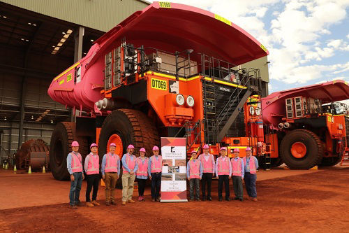 Executive chairman Rinehart (fifth from left) and related parties take commemorative photo in front of the delivered dump trucks