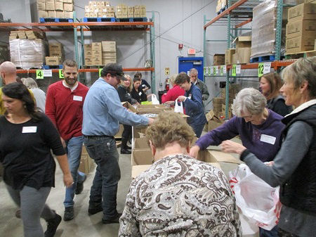 H-E Parts Dom-Ex Volunteers to fill food bags for united way’s buddy backpack program