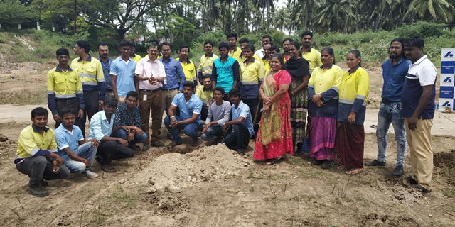 Commemorative photo with participating employees at tree planting site