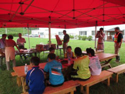 Students listen to a lecture while eating lunch