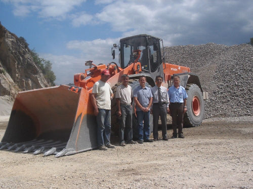 The people on the picture are (from left to right) Eric Valtou (Opérator) , Philippe Persiani (Quarry Manager), Frédéric Monteil (SMTL Manager), Takuya Kawamoto (Hitachi Construction Machinery Europe, France Branch, General Manager) and Michel Monteil (SMTL General Manager)