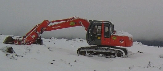 Zaxis 160LC working in the snowy mountain