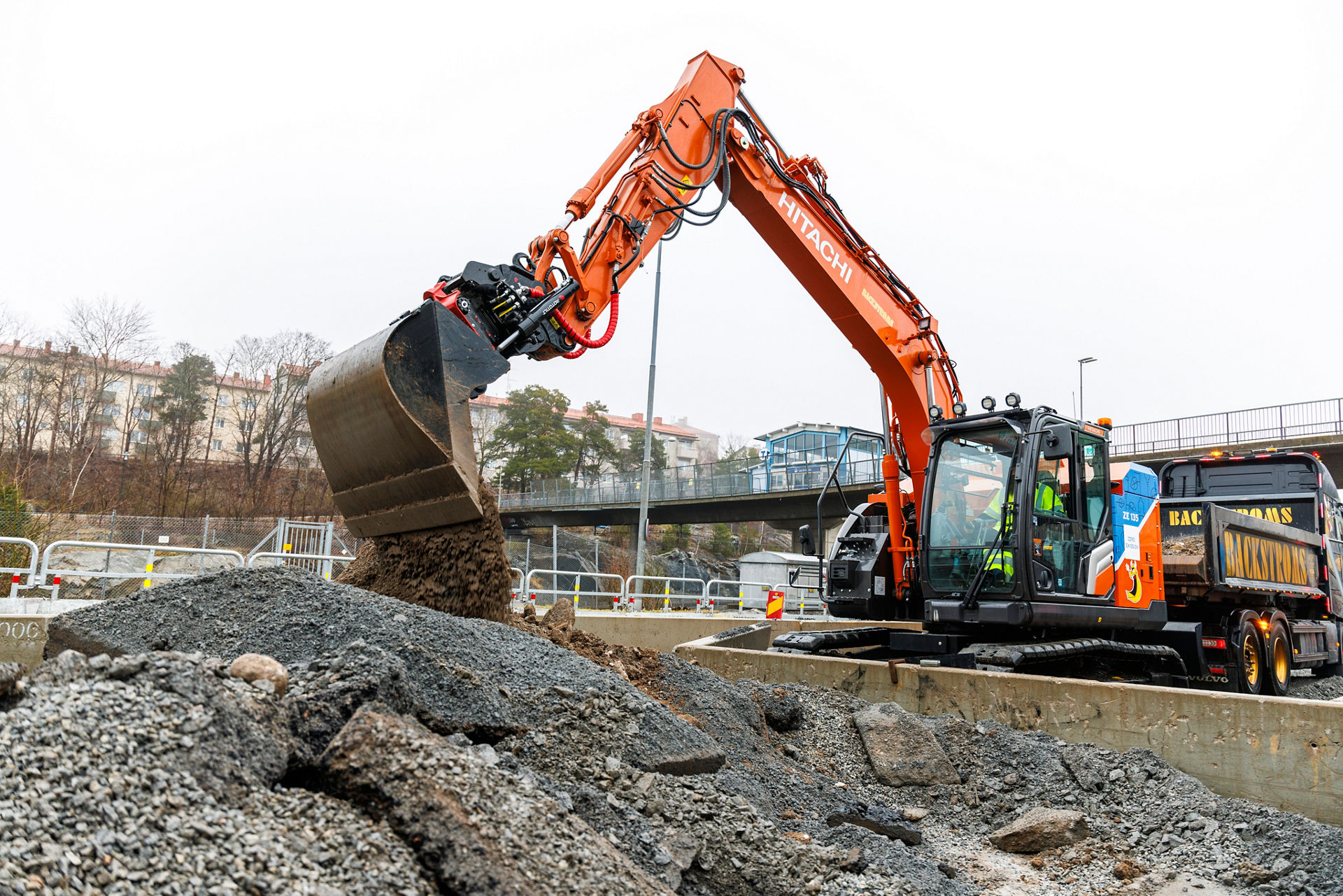 An inflatable monkey attached to a Hitachi excavator at Oga Fair, Switzerland