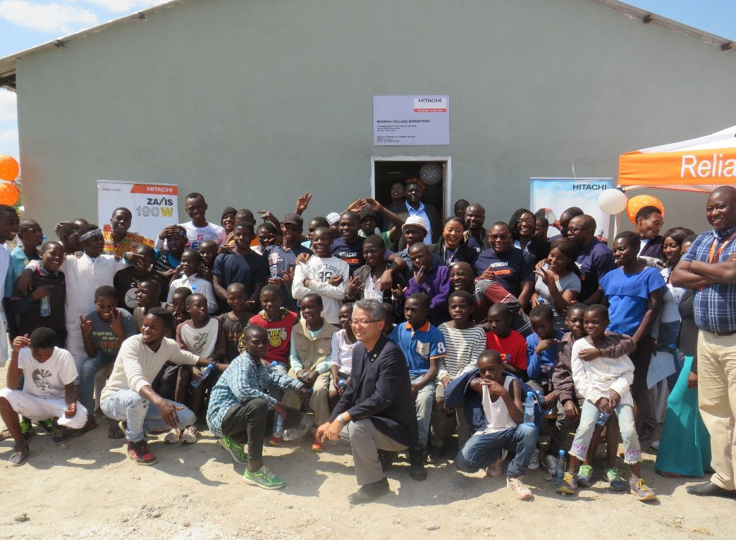HCMZ President (Center, front) and employees with children after handover of the dormitory