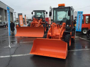 Wheel loaders on display outside