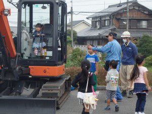 Children had a chance to sit in a compact excavator