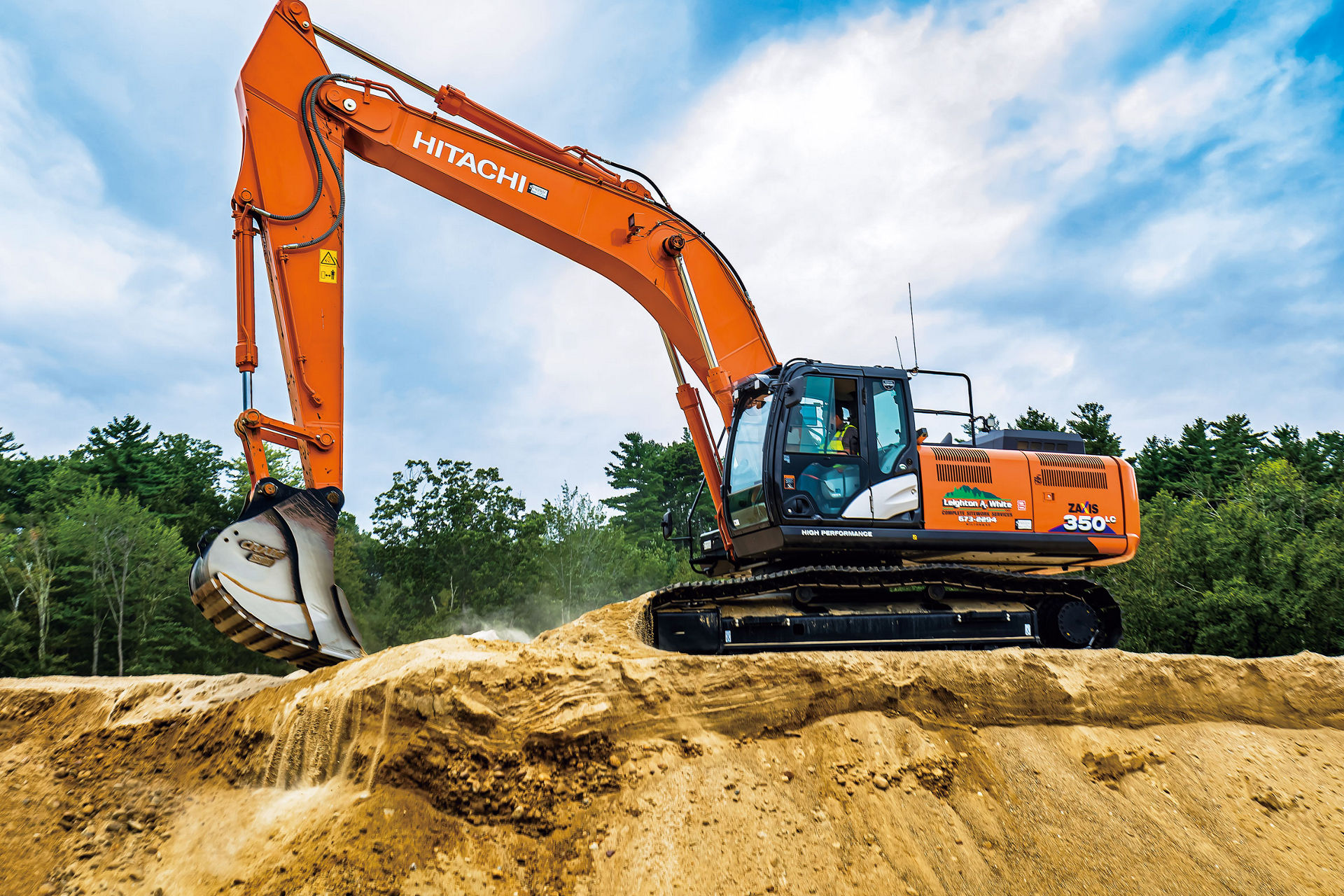 Large hydraulic excavator “ZX350” in action on construction site.