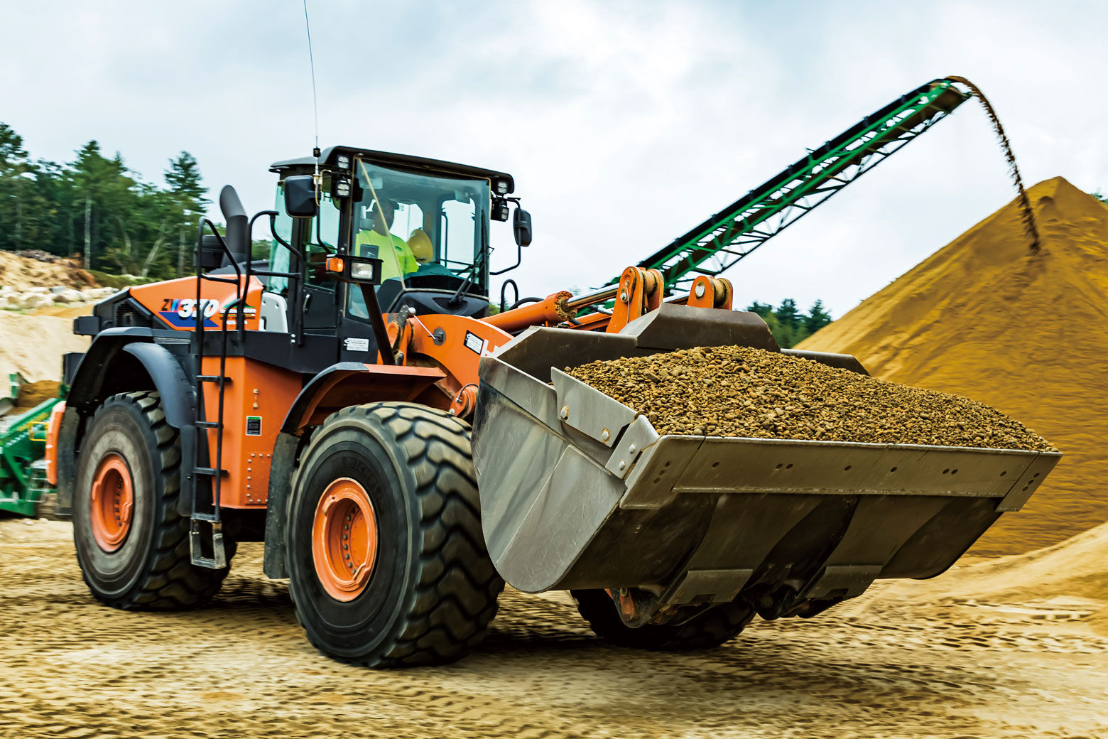 Equipment from Hitachi Construction Machinery plays an active role in excavating and transporting gravel.