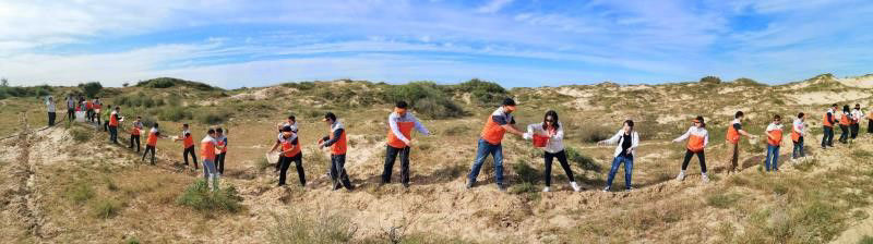 Volunteers watering by bucket brigade method