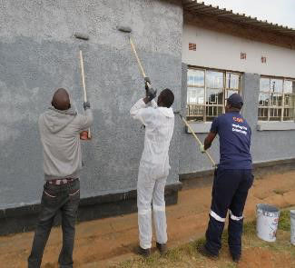 Employees painting walls