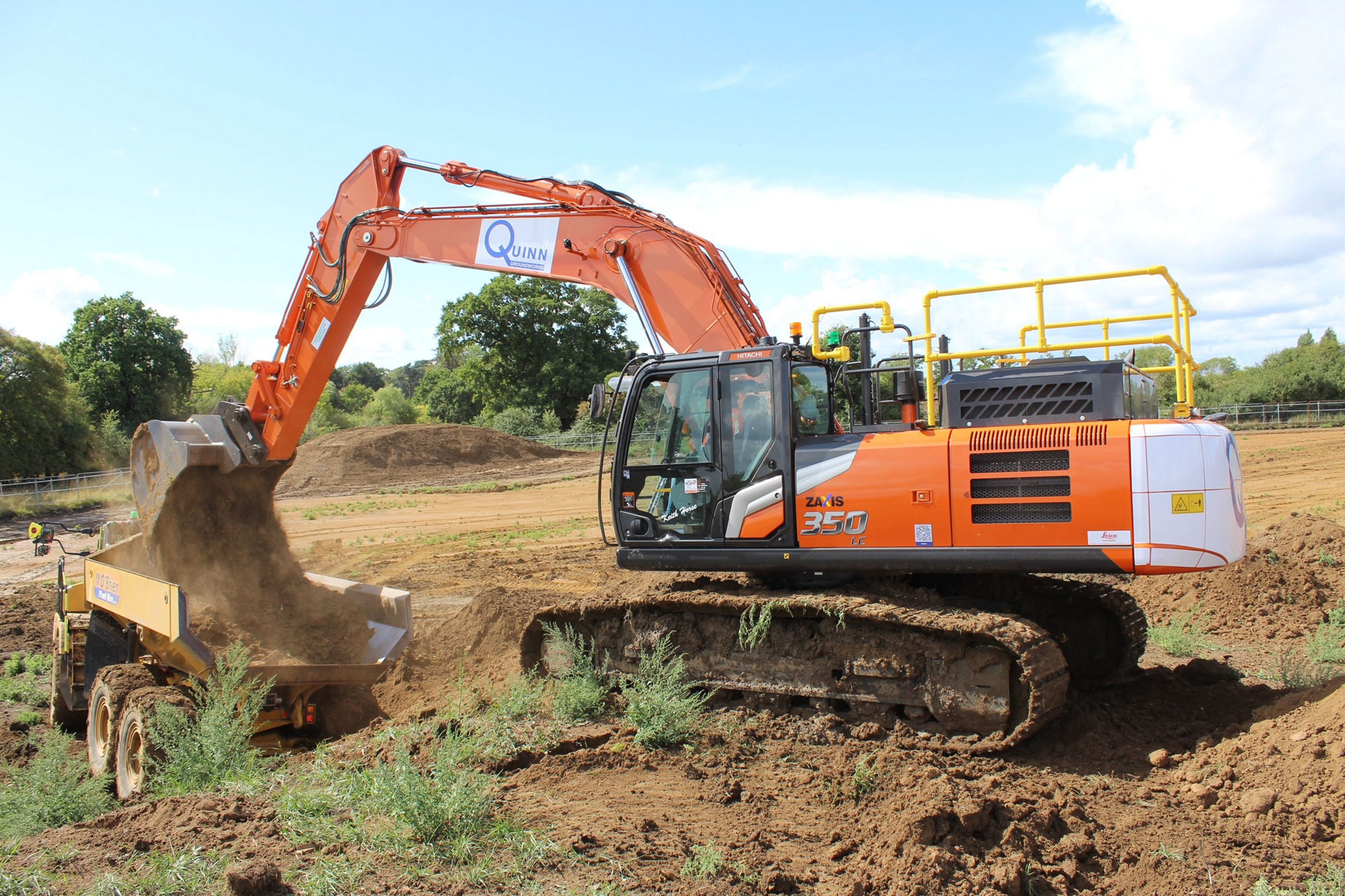 an orange hitachi machine digging quinn 