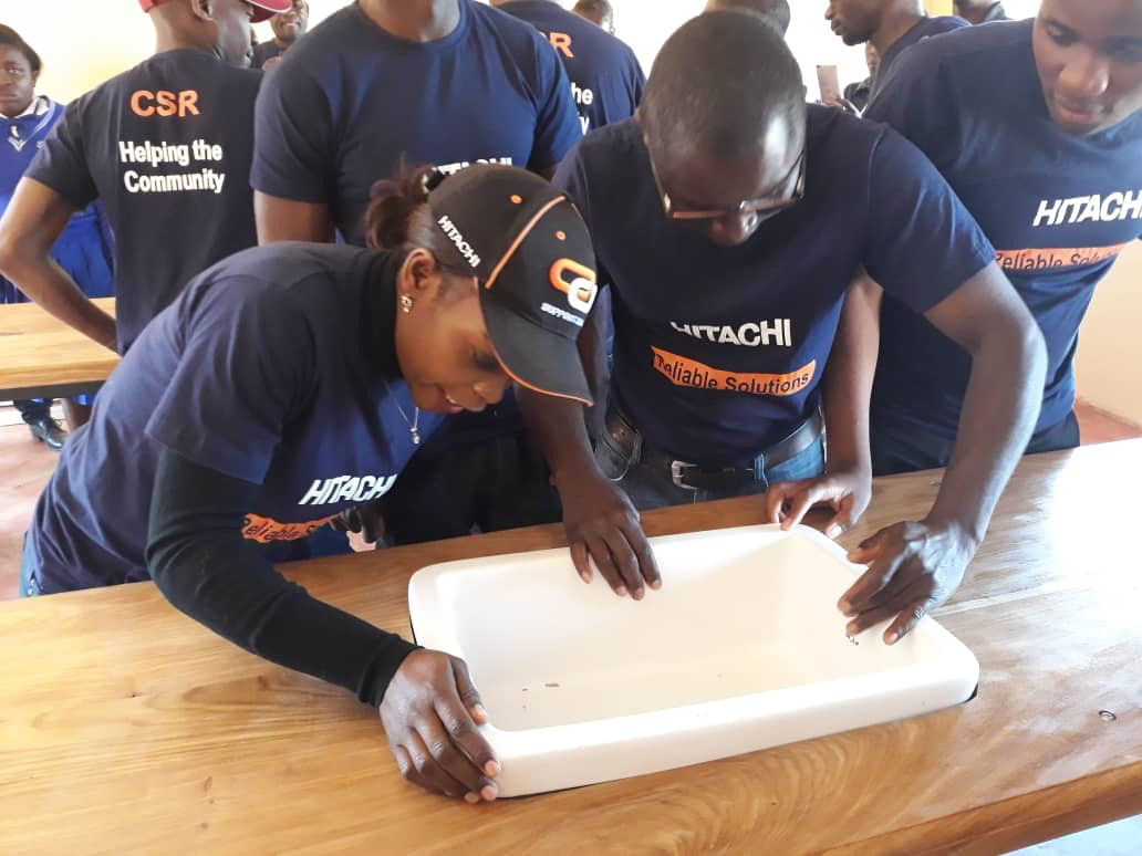 Employees setting water sinks carefully